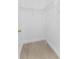 Walk-in closet with built-in shelving, modern floors, and white walls at 11709 N Armenia Ave, Tampa, FL 33612