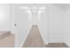 Bright hallway with modern flooring and white walls, illuminated by recessed lighting at 11709 N Armenia Ave, Tampa, FL 33612