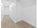 Hallway with modern floors, white walls, and recessed lighting at 11709 N Armenia Ave, Tampa, FL 33612