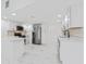 Modern white kitchen with stainless steel appliances and marble floors at 11709 N Armenia Ave, Tampa, FL 33612