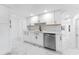 Modern kitchen featuring white cabinets, stainless appliances and marble tile flooring at 11709 N Armenia Ave, Tampa, FL 33612