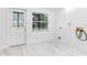 Laundry room with white walls, marble tile floors, and window at 11709 N Armenia Ave, Tampa, FL 33612