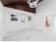 Bright room featuring a wood plank ceiling, modern lighting and marble tile flooring at 11709 N Armenia Ave, Tampa, FL 33612