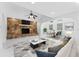 Bright living room with stone fireplace, modern decor, and a seamless open floor plan at 11709 N Armenia Ave, Tampa, FL 33612