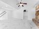 Bright living room with marble floors, stone fireplace, and modern ceiling fan at 11709 N Armenia Ave, Tampa, FL 33612