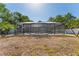 Enclosed screened-in pool and patio area overlooks the yard, creating a private outdoor oasis at 11709 N Armenia Ave, Tampa, FL 33612