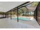 A screened in pool featuring a spacious deck area, a pool, and a hot tub at 11709 N Armenia Ave, Tampa, FL 33612