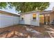 A storage shed in the backyard with a small door and shuttered windows at 11709 N Armenia Ave, Tampa, FL 33612