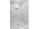 Elegant walk-in shower with white marble tile and built-in niche at 11709 N Armenia Ave, Tampa, FL 33612
