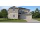 Charming two-story home featuring a symmetrical facade, well-maintained lawn, and a two-car garage at 11939 Brae Way, Dade City, FL 33525