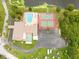 Aerial view of community amenities including pool, tennis court, lake, and lawn bowling at 1234 11Th Se Cir, Largo, FL 33771