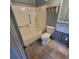 Tiled bathroom featuring a white toilet, shower and bathtub ready for remodeling at 1234 11Th Se Cir, Largo, FL 33771