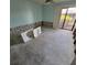 Bedroom with a ceiling fan, large window and patio access, awaiting remodeling at 1234 11Th Se Cir, Largo, FL 33771
