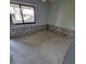 Bedroom featuring exposed concrete and large window to back yard, awaits finishing and customization at 1234 11Th Se Cir, Largo, FL 33771