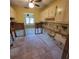 Tiled kitchen area ready for renovation, featuring upper cabinets and exposed plumbing at 1234 11Th Se Cir, Largo, FL 33771