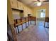 Tiled kitchen area ready for renovation, featuring upper cabinets and exposed plumbing at 1234 11Th Se Cir, Largo, FL 33771