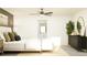 Bright main bedroom featuring ceiling fan, dresser, and ensuite bathroom at 13139 Empress Jewel Trl, Parrish, FL 34219