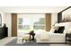 Stylish bedroom with neutral tones, large windows, and chic furnishings creating a bright and relaxing ambiance at 13167 Violet Flame Ave, Wimauma, FL 33598