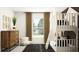 Bright bedroom with a unique bunk bed design, dresser, and a window that offers a peaceful view at 13167 Violet Flame Ave, Wimauma, FL 33598