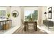 A modern dining room with a wooden table, stylish chairs, and sliding glass doors for bright natural light at 13167 Violet Flame Ave, Wimauma, FL 33598