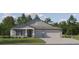 Beautiful single-story home featuring a three-car garage, manicured lawn, and classic architectural details at 13167 Violet Flame Ave, Wimauma, FL 33598