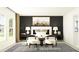 A serene main bedroom featuring a black accent wall, neutral decor, a large window, and stylish furnishings at 13167 Violet Flame Ave, Wimauma, FL 33598