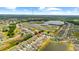 An aerial view showcases the community, proximity to a lake, and natural surroundings at 13380 Great Plains Dr, Riverview, FL 33579