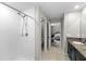 Bright bathroom with a tiled walk-in shower and granite countertops and view to Primary bedroom at 13380 Great Plains Dr, Riverview, FL 33579