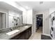 Spacious bathroom with double sinks, granite countertops, and a walk-in closet at 13380 Great Plains Dr, Riverview, FL 33579