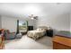 Comfortable bedroom with a ceiling fan, a window with green curtains and an inviting quilt bed at 13380 Great Plains Dr, Riverview, FL 33579