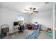 Bright bedroom with a ceiling fan and ample space for a desk and crafting area at 13380 Great Plains Dr, Riverview, FL 33579
