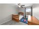 Cozy bedroom featuring a charming wooden crib, a ceiling fan and a colorful ' rug at 13380 Great Plains Dr, Riverview, FL 33579