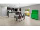 Bright dining area adjacent to the kitchen with stainless appliances and sliding door access to the backyard at 13380 Great Plains Dr, Riverview, FL 33579
