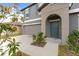Close up of the front exterior shows a well-maintained facade, teal door, and landscaping at 13380 Great Plains Dr, Riverview, FL 33579
