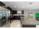 Well-equipped kitchen with granite counters, stainless appliances, ample cabinet space and backyard views at 13380 Great Plains Dr, Riverview, FL 33579