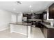 Stylish kitchen with granite counters, stainless steel appliances, dark cabinetry, and a functional kitchen island at 13380 Great Plains Dr, Riverview, FL 33579