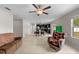 Bright living space with tile floors, ceiling fan, and an open layout seamlessly connecting to the kitchen at 13380 Great Plains Dr, Riverview, FL 33579