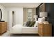 A well-lit bedroom with neutral tones, soft textures, and a view to the outside at 13515 White Gold Run, Parrish, FL 34219