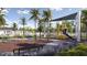 Community playground featuring a safe play area, colorful equipment, and beautiful landscaping at 13515 White Gold Run, Parrish, FL 34219