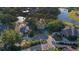 Aerial shot showcasing lush landscaping and neighborhood charm with lake views at 15704 Mifflin Ct, Tampa, FL 33647