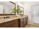 Elegant bathroom with double sinks, granite countertops, and warm wood cabinetry, plus a view of the outdoors at 15704 Mifflin Ct, Tampa, FL 33647