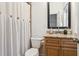 Well-appointed bathroom featuring a vanity, toilet, and linen shower curtain at 15704 Mifflin Ct, Tampa, FL 33647