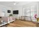 Bright bedroom with ample natural light, featuring wood floors, a ceiling fan, and contemporary furnishings at 15704 Mifflin Ct, Tampa, FL 33647
