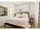 Bright bedroom with a comfortable bed, natural light, and stylish decor creates a relaxing atmosphere at 15704 Mifflin Ct, Tampa, FL 33647