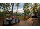 Outdoor deck featuring a dining table with seating and views of landscaping at 15704 Mifflin Ct, Tampa, FL 33647