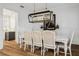 Bright dining room with hardwood floors, a modern chandelier, and seating for six at 15704 Mifflin Ct, Tampa, FL 33647
