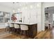 Open kitchen with a large island, seating, modern appliances, and custom cabinets at 15704 Mifflin Ct, Tampa, FL 33647