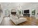 Bright living room with a fireplace, modern decor, and ample natural light showcasing the elegant interior design at 15704 Mifflin Ct, Tampa, FL 33647