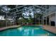 Sparkling pool with a screened-in enclosure and tranquil backyard views at 15704 Mifflin Ct, Tampa, FL 33647