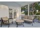 Charming porch with neutral furniture provides a cozy outdoor living space with great views at 15704 Mifflin Ct, Tampa, FL 33647